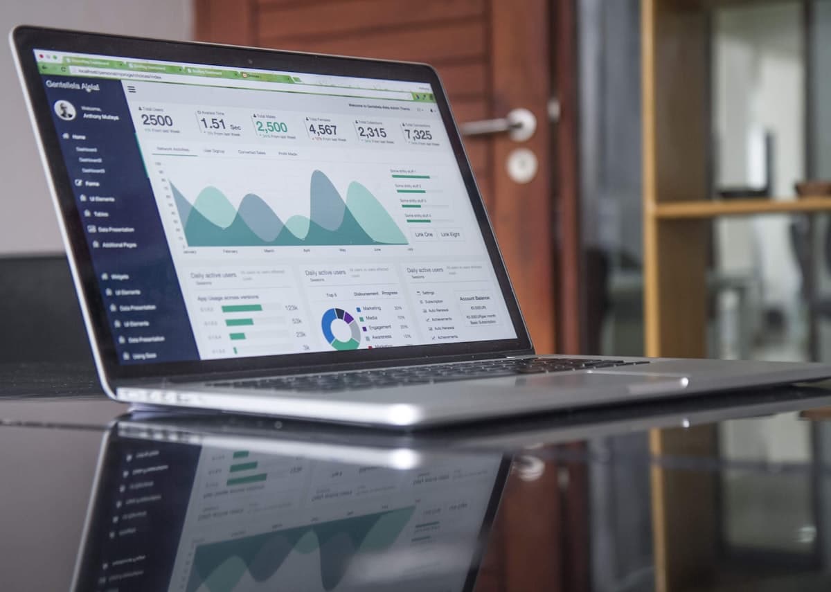 Trader analyzing charts on laptop